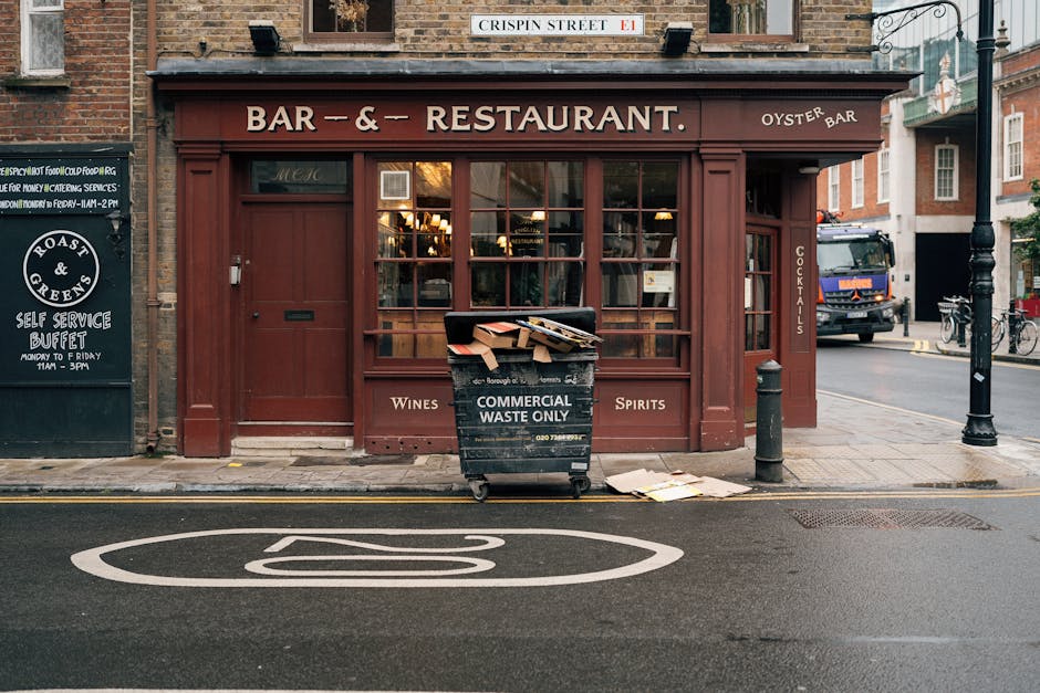 A close-up view of a beige brick wall at the Westminster Council's Bell Yard WC2, showing a street sign with black and red text on a white background, indicating location details. Below the sign, ther